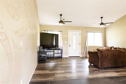 living room featuring ceiling fan and dark hardwood / wood-style flooring