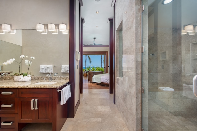 bathroom with tile floors, a shower with door, ornamental molding, and vanity