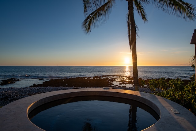 pool at dusk with a water view