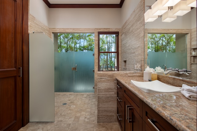 bathroom featuring ornamental molding, tile flooring, tile walls, and large vanity