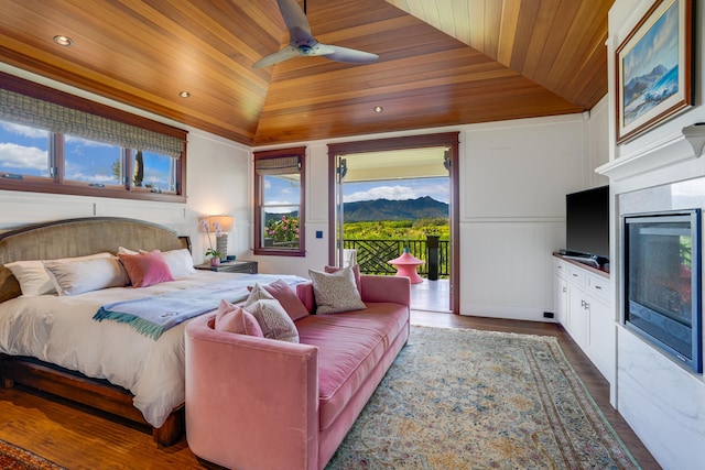 bedroom with vaulted ceiling, hardwood / wood-style floors, access to outside, ceiling fan, and wooden ceiling