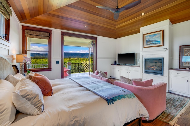 bedroom with lofted ceiling, wood ceiling, access to outside, hardwood / wood-style flooring, and ceiling fan