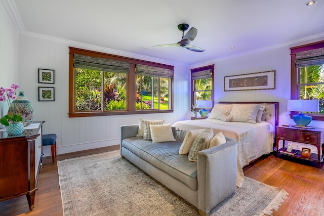 bedroom with crown molding, ceiling fan, and wood-type flooring