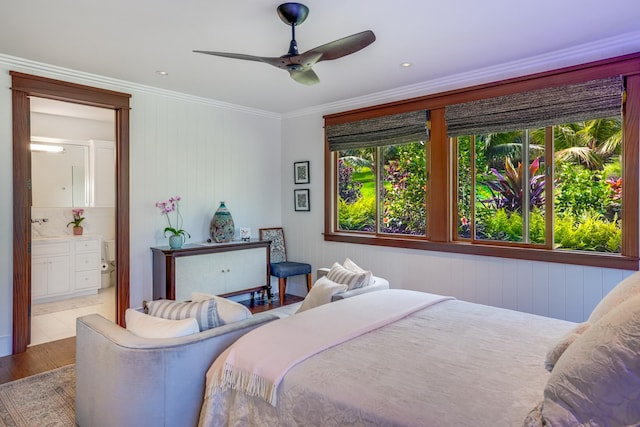 bedroom with ceiling fan, ensuite bathroom, ornamental molding, and light wood-type flooring