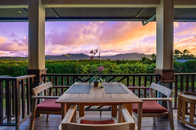 deck at dusk featuring a mountain view