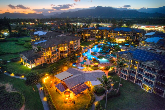 aerial view at dusk featuring a mountain view