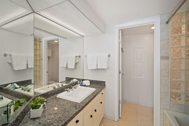 bathroom featuring tile flooring,  shower combination, and large vanity