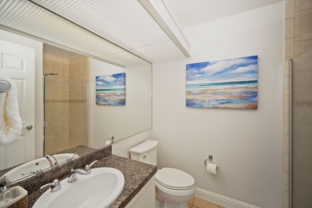 bathroom featuring vanity, tile floors, and toilet