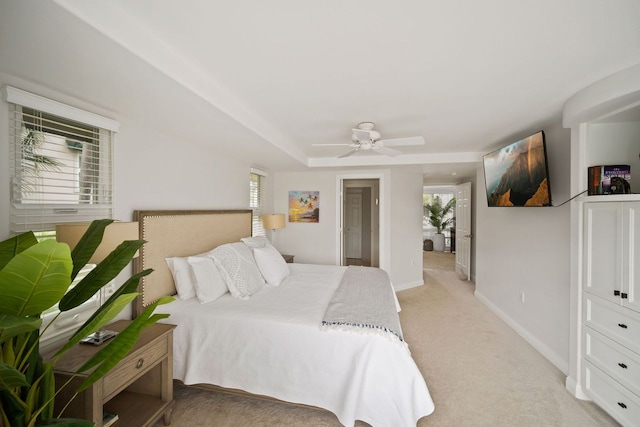 bedroom with light colored carpet, multiple windows, and ceiling fan