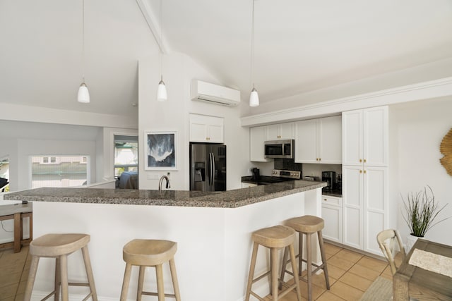 kitchen with decorative light fixtures, appliances with stainless steel finishes, light tile floors, and a wall unit AC