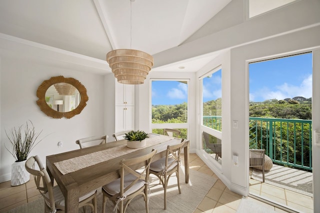 dining space with light tile floors and lofted ceiling