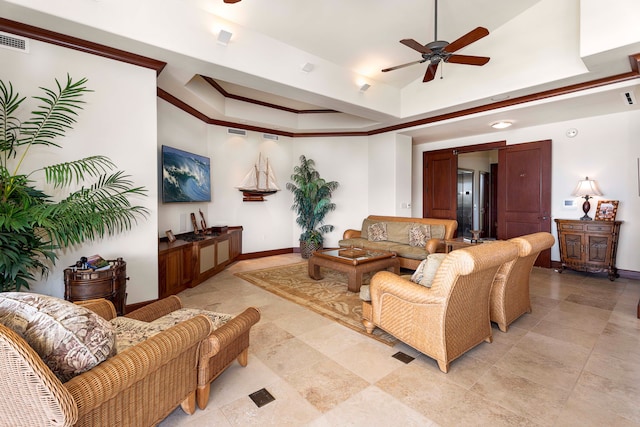 living room featuring tile flooring, ceiling fan, and a raised ceiling