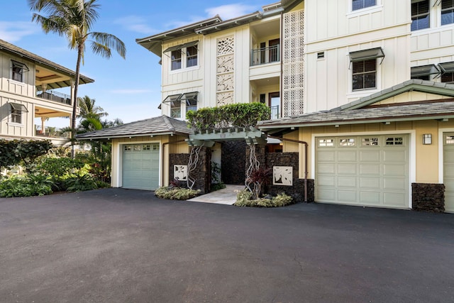 multi unit property featuring a garage and a balcony