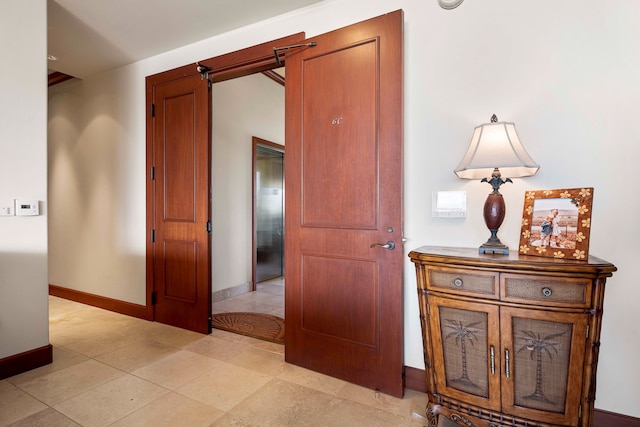 hall with light tile flooring and elevator