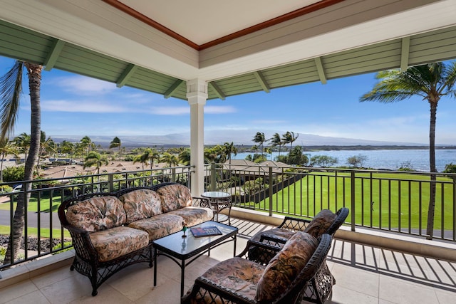 view of terrace featuring an outdoor living space, a water view, and a balcony