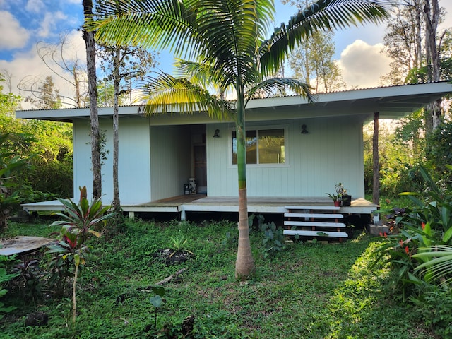 rear view of property with a yard