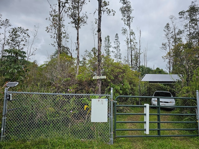 view of gate featuring a lawn