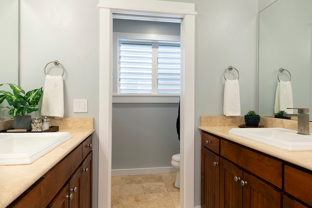 bathroom featuring toilet, tile flooring, and vanity