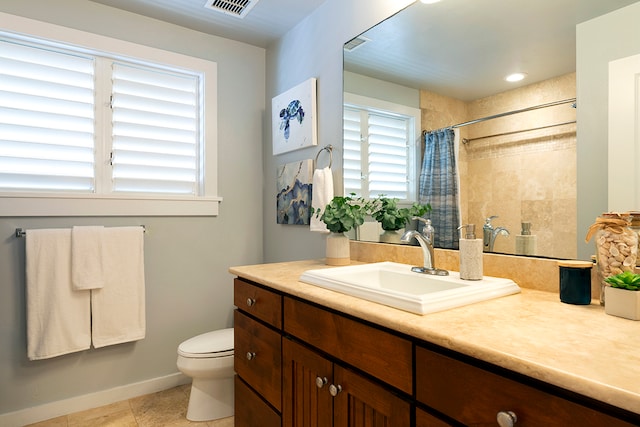 bathroom featuring toilet, tile flooring, and vanity