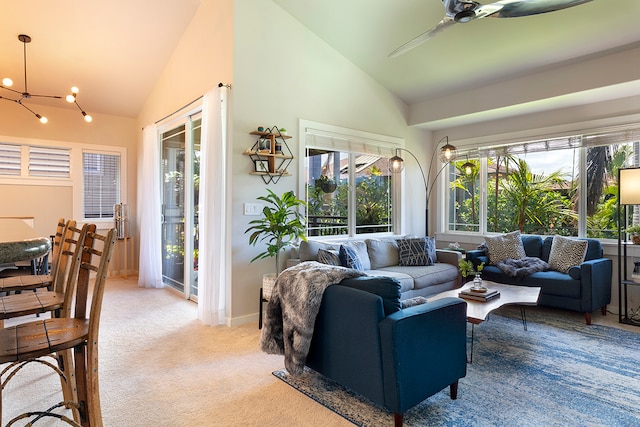 interior space with high vaulted ceiling, ceiling fan with notable chandelier, and carpet flooring