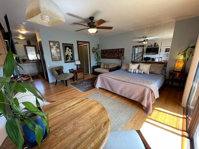 bedroom featuring ceiling fan and hardwood / wood-style flooring