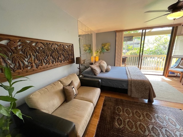 bedroom with wood-type flooring, ceiling fan, and access to exterior