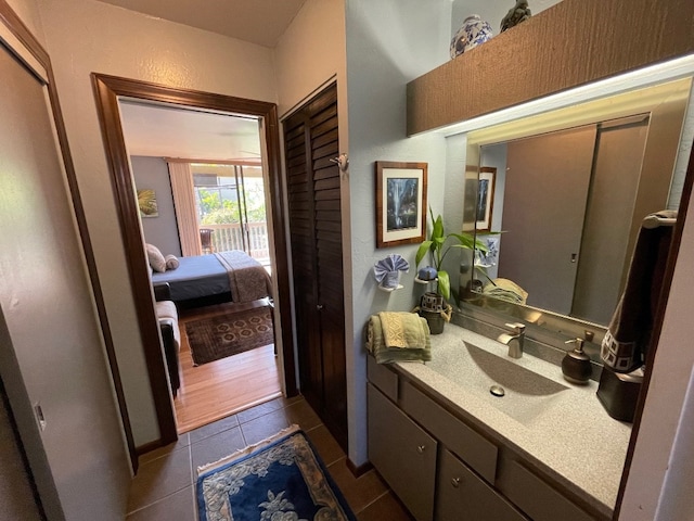 bathroom with wood-type flooring and large vanity