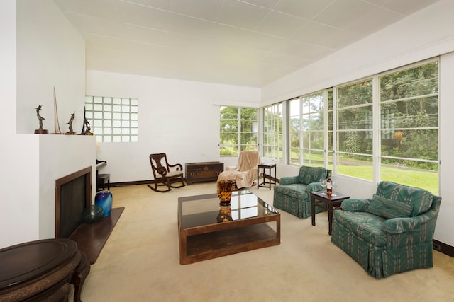 living room with carpet and a fireplace