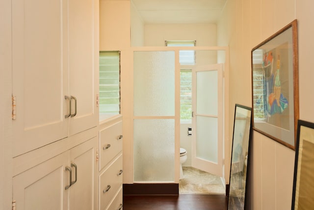 bathroom featuring wood-type flooring and toilet