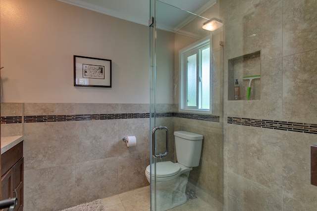 bathroom with tile walls, toilet, tile flooring, vanity, and ornamental molding