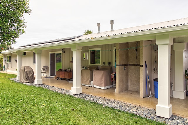 rear view of property featuring a yard