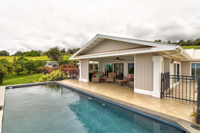 view of pool with a patio and ceiling fan