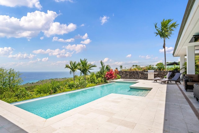 view of pool featuring a patio and a water view