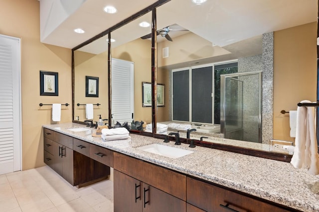 bathroom with dual vanity, ceiling fan, and tile floors