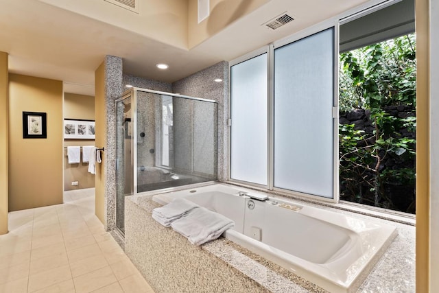 bathroom featuring independent shower and bath and tile flooring