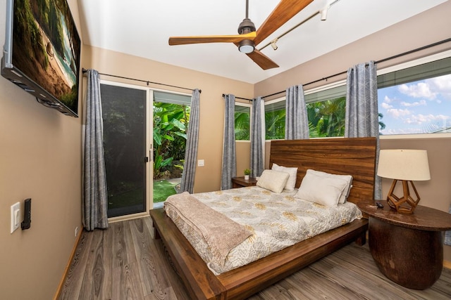 bedroom featuring ceiling fan, hardwood / wood-style flooring, and access to exterior