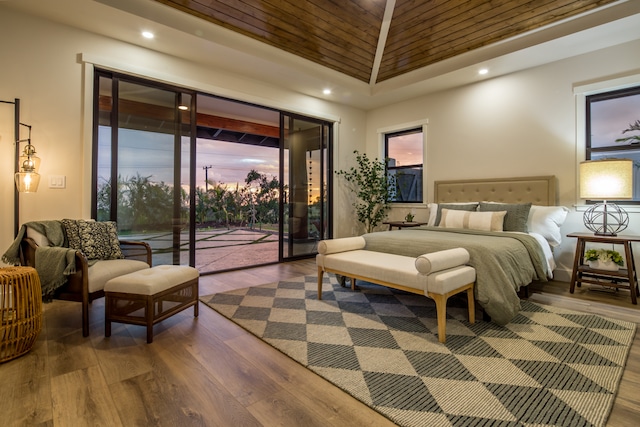 bedroom featuring access to outside, wooden ceiling, wood-type flooring, and vaulted ceiling