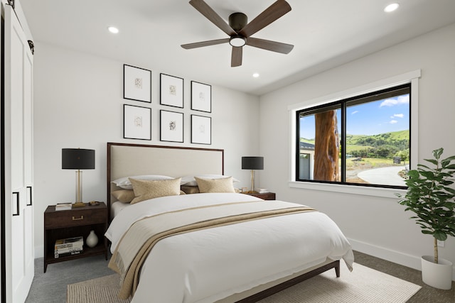 bedroom featuring dark colored carpet and ceiling fan