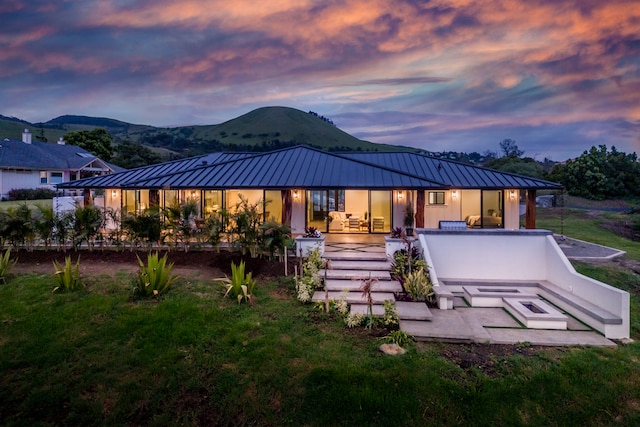 back house at dusk with a mountain view