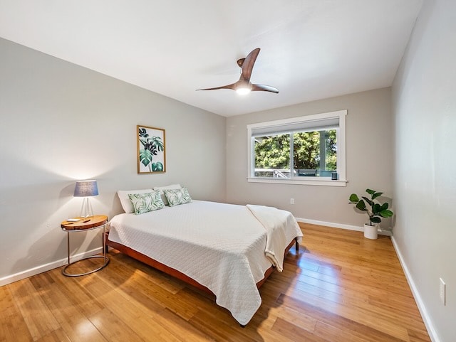 bedroom with hardwood / wood-style flooring and ceiling fan