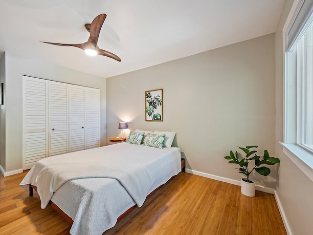 bedroom with a closet, ceiling fan, and light hardwood / wood-style flooring