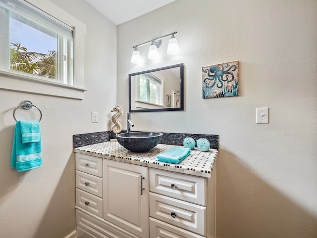 bathroom with plenty of natural light and vanity