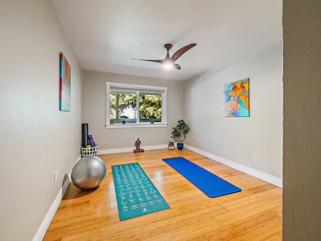 workout room with wood-type flooring and ceiling fan