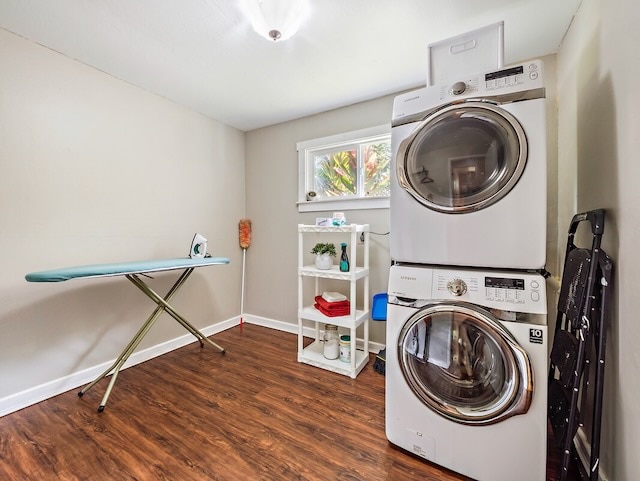 clothes washing area with stacked washer and clothes dryer and hardwood / wood-style flooring