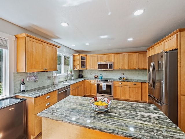 kitchen featuring plenty of natural light, tasteful backsplash, and appliances with stainless steel finishes