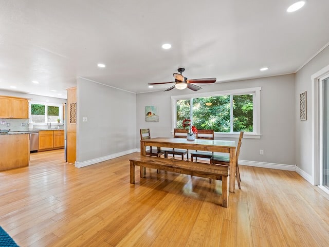 dining room featuring ceiling fan, light hardwood / wood-style flooring, and sink