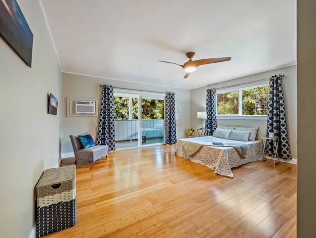 bedroom with hardwood / wood-style floors, ceiling fan, access to outside, and multiple windows