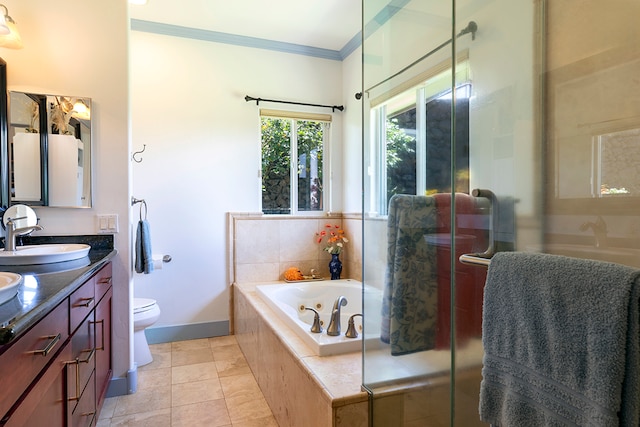 bathroom featuring toilet, tiled bath, tile patterned flooring, crown molding, and vanity