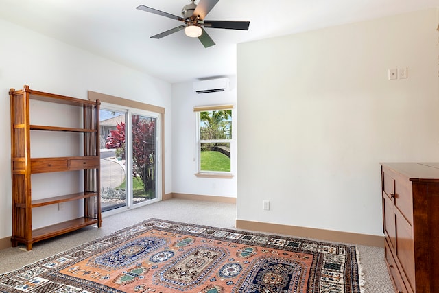 interior space featuring a wall mounted AC, light colored carpet, and ceiling fan