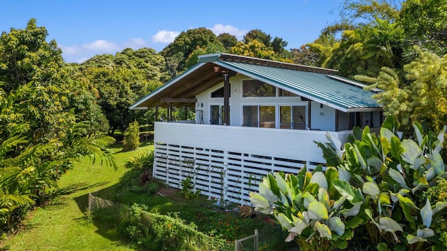 view of property exterior featuring a lawn